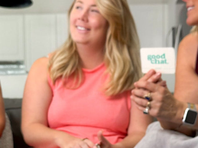 Two women talking over the Money conversation deck at home in bright daylight