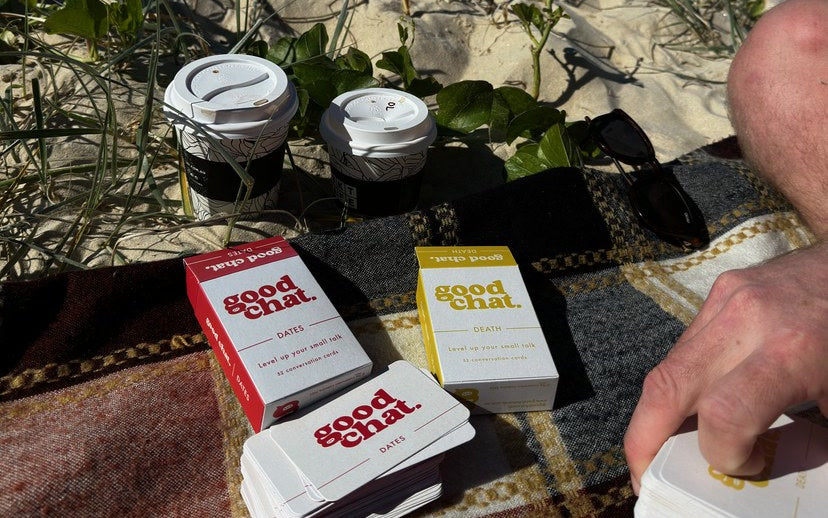 Dates conversation deck and coffees on a beach picnic blanket with the ocean behind
