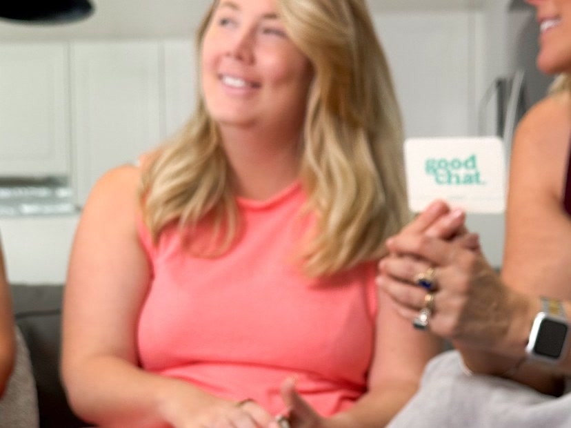 Two women talking over the Money conversation deck at home in bright daylight