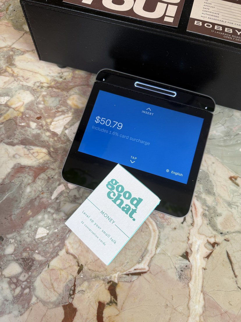 Good Chat Money deck propped on an EFTPOS terminal, cheeky money moment